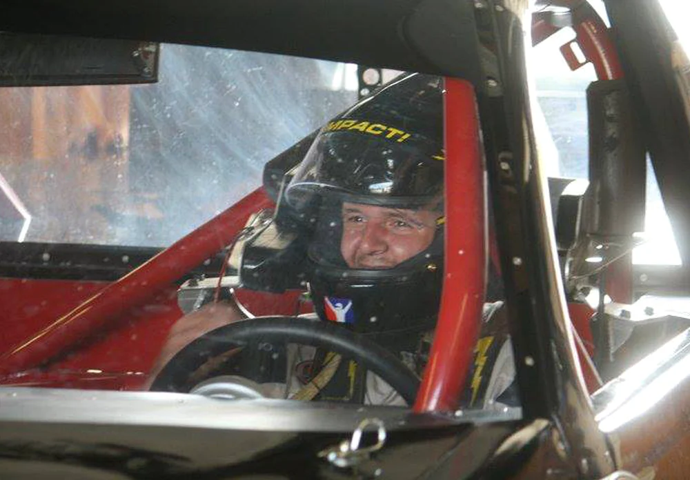 Tyler Hudson behind the wheel during a real-world racing opportunity